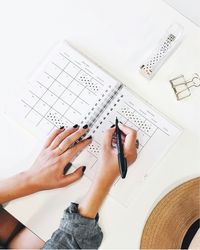 woman writing notes down in calendar agenda